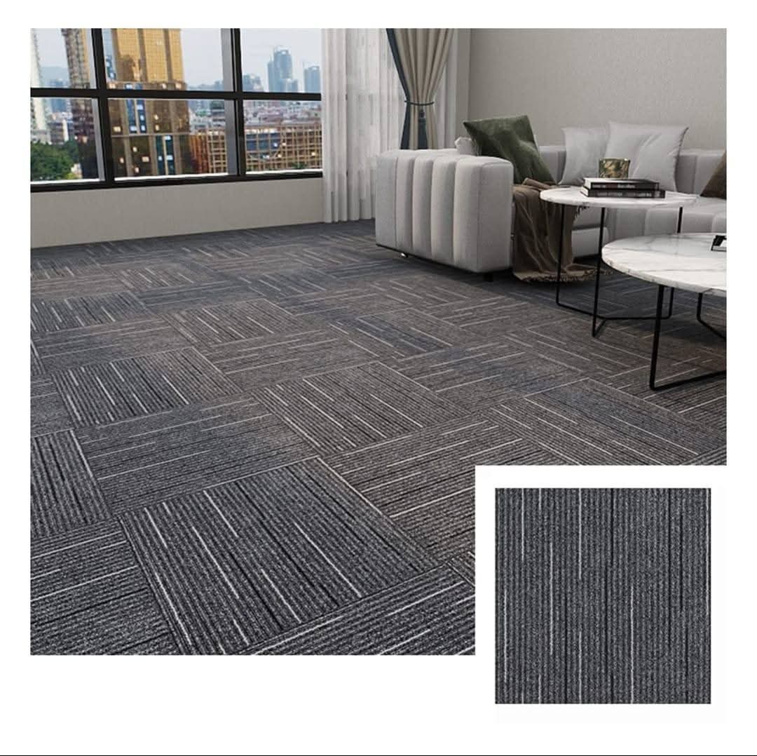 Grey striped carpet tiles laid in a quarter-turn pattern across an office floor